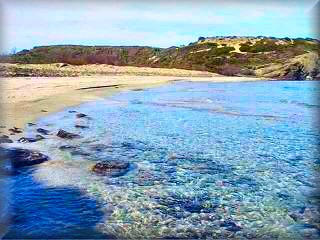 Playa de Capifort en cala Morella, una bella playa virgen de cristalinas aguas y grandes lomas de dunas, dentro del Parque de Es Grao en el area de Faro de Favaritx